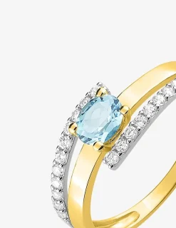 Bague monture bicolore or 750‰, topaze bleue traitée et oxydes de zirconium SO OR