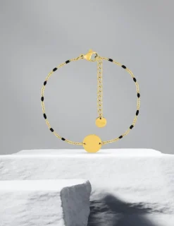 Bracelet fantaisie noir et acier doré, plaque ronde SO OR